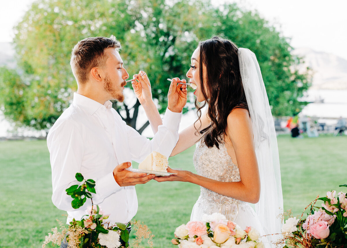 Bride and groom eating cake at Flathead Lake Forevers in Big Arm, MT