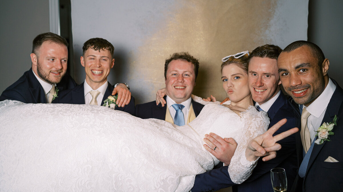Bride, groom and guests in wedding portrait studio wedding photobooth