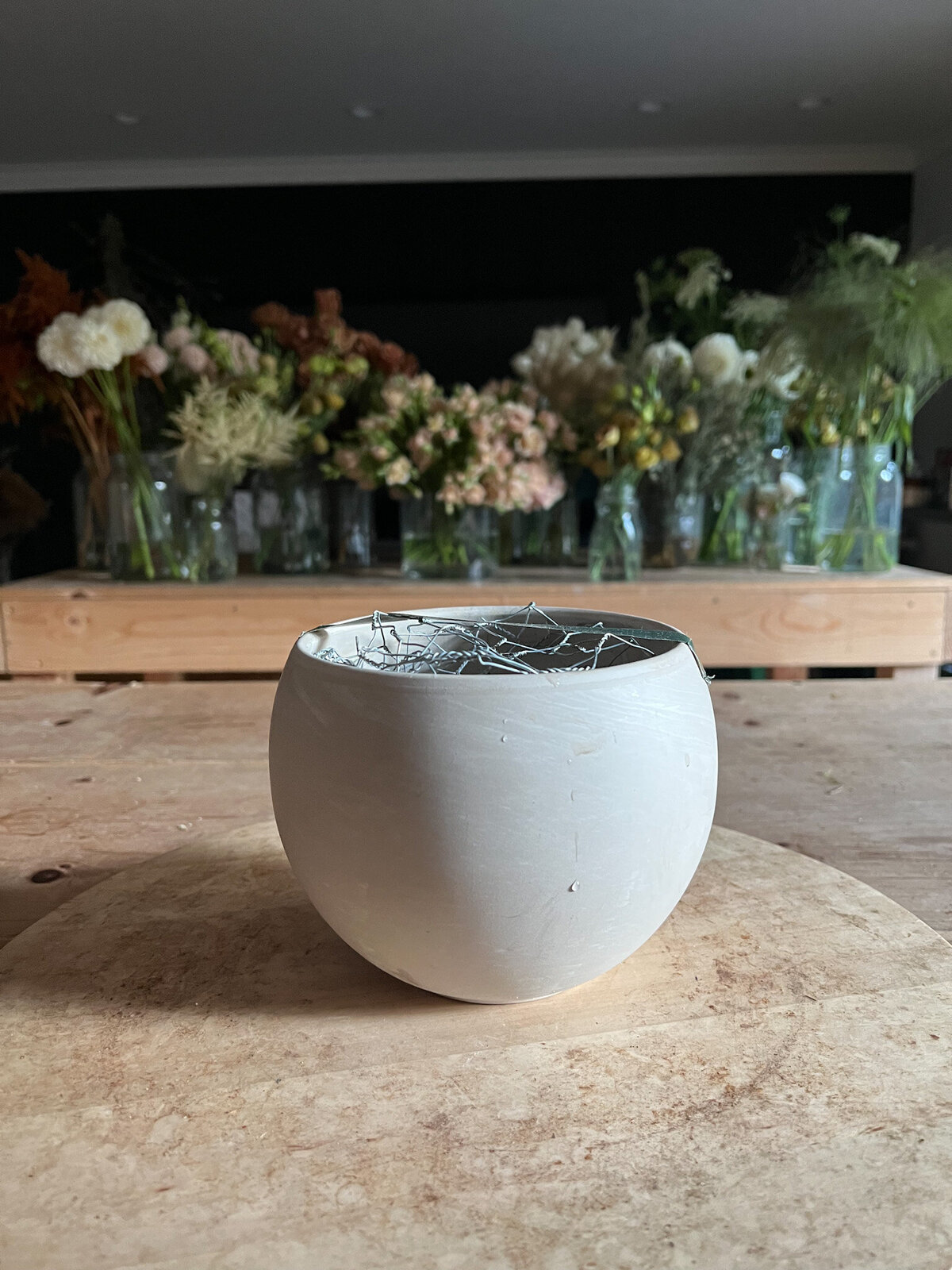 vase with flowers in the background