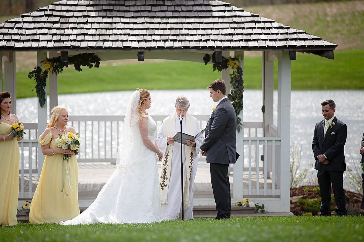 Bride and Groom during lakeside wedding ceremony at White Barn in Prospect, PA