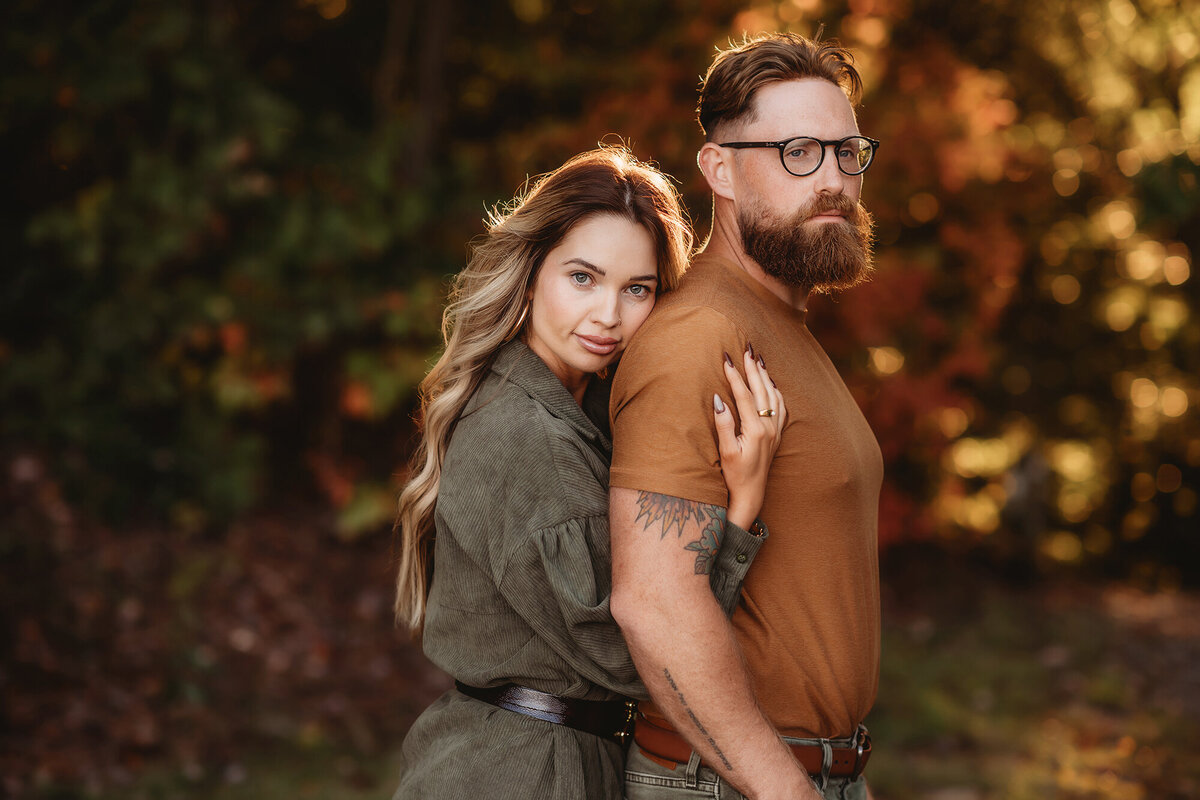 Wife embraces her husband during Fall Photoshoot in Asheville, NC.
