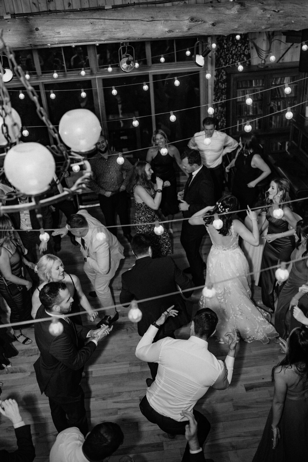 Overhead shot of all the wedding guests have fun while dancing at the wedding reception