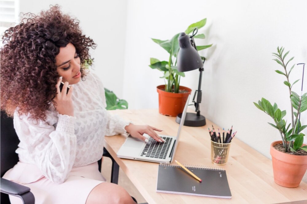 busy business woman on laptop and phone