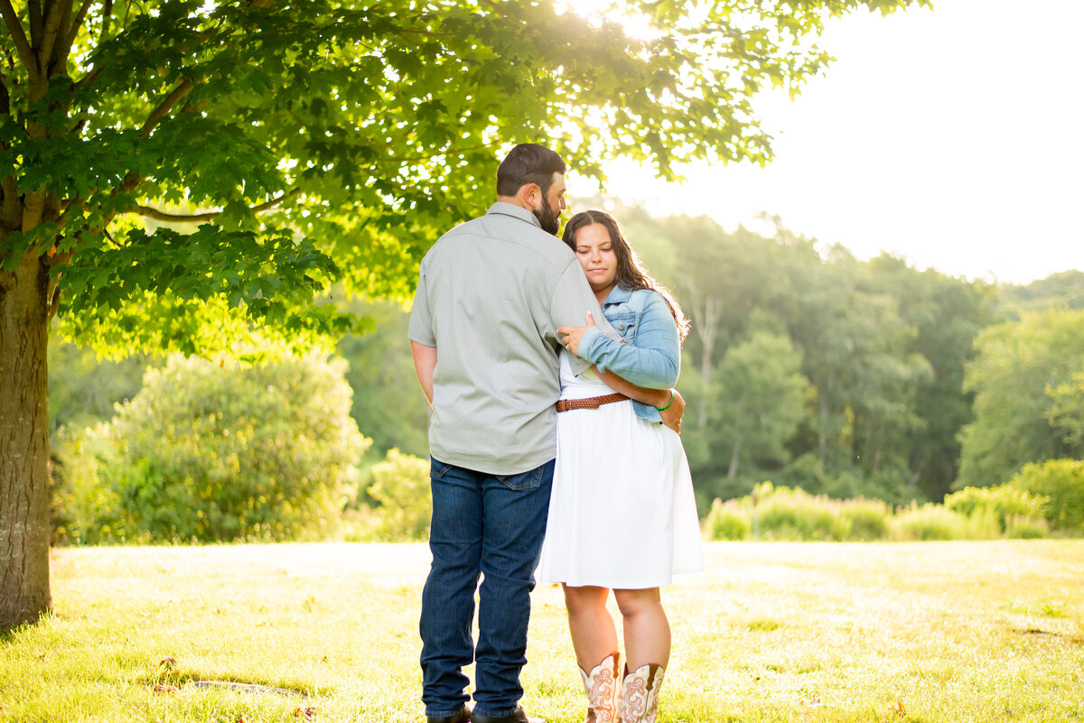 Witness the rustic beauty of an engagement under a tree at sunrise in Southford Falls, Connecticut. Our photo captures the genuine love story amidst the golden morning light.