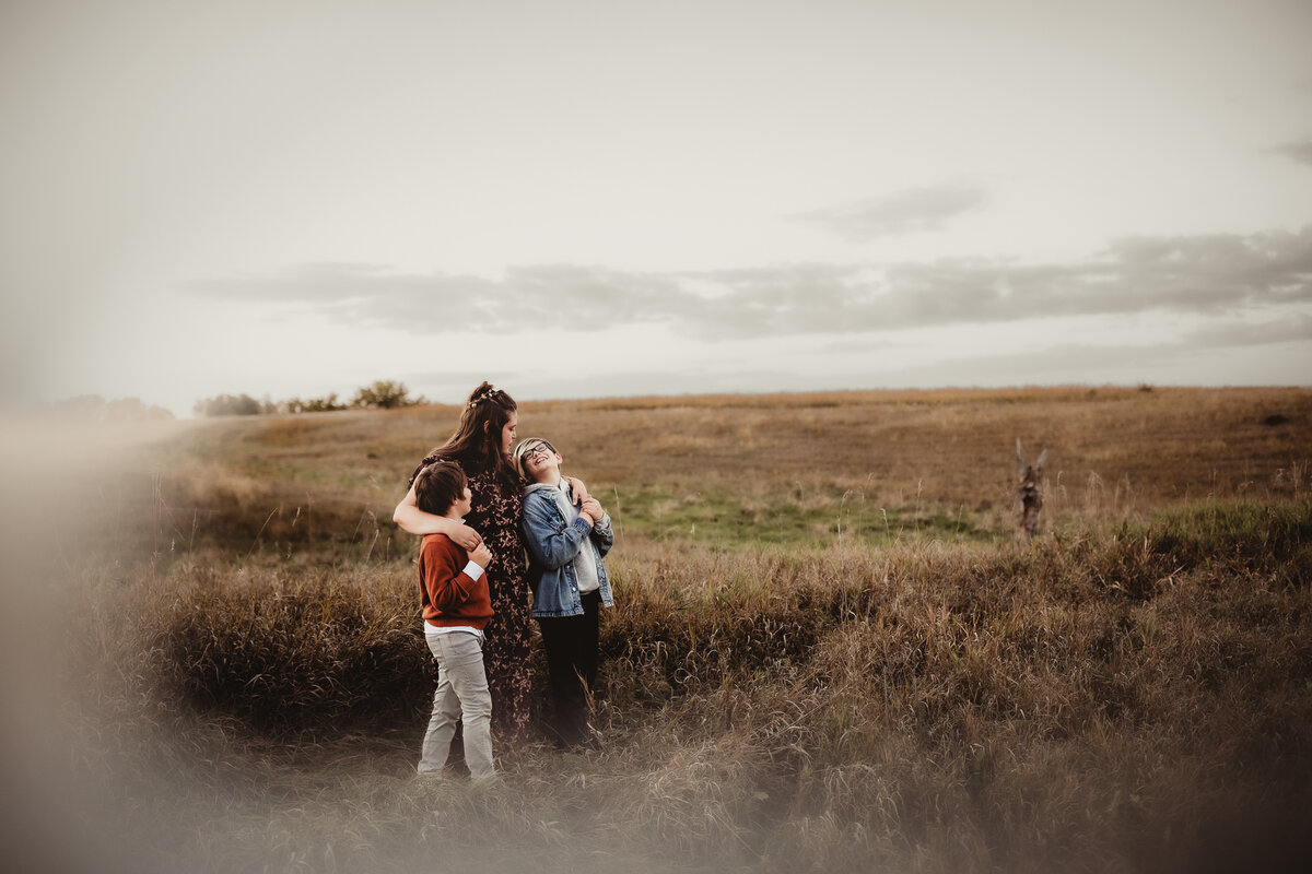 mom and boys in open field
