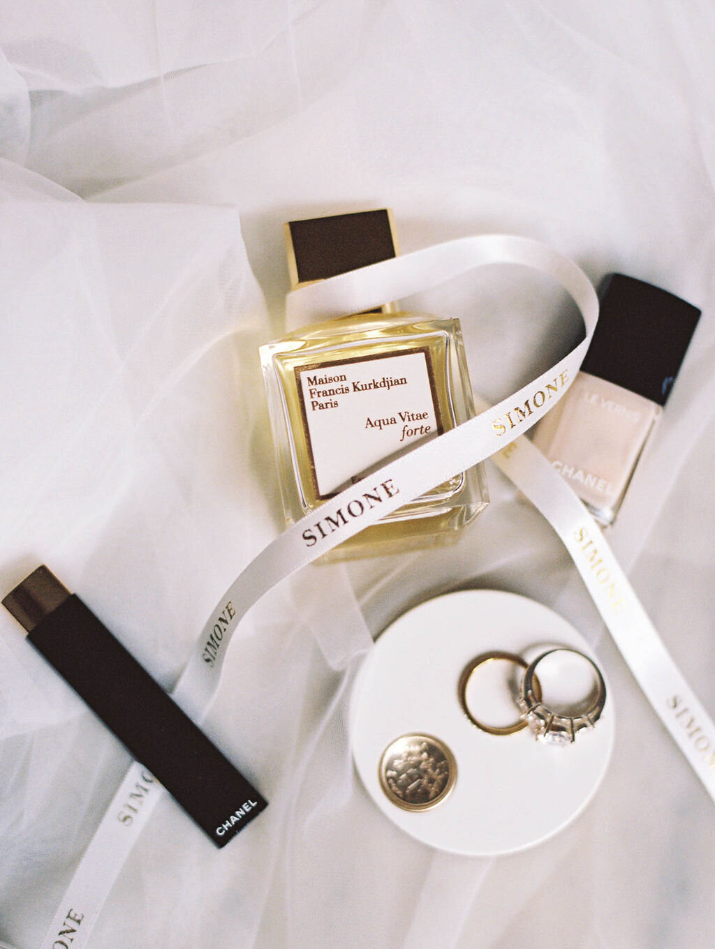 Wedding details including rings, makeup, and perfume, taken by photography chicago wedding expert Allison Francois Photography