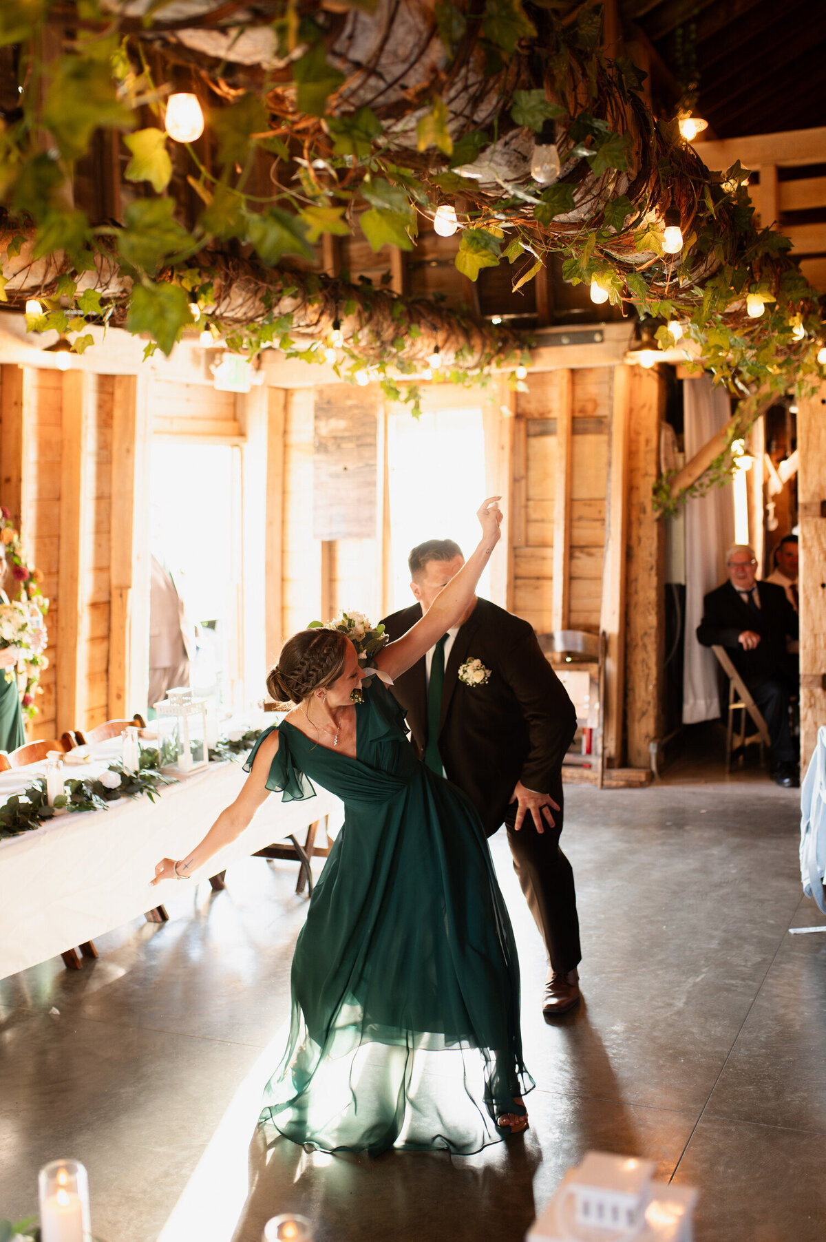 A bridesmaid and groomsman break it down on the dance floor during a wedding at Knotting Hill Farm in Jordanville, NY.