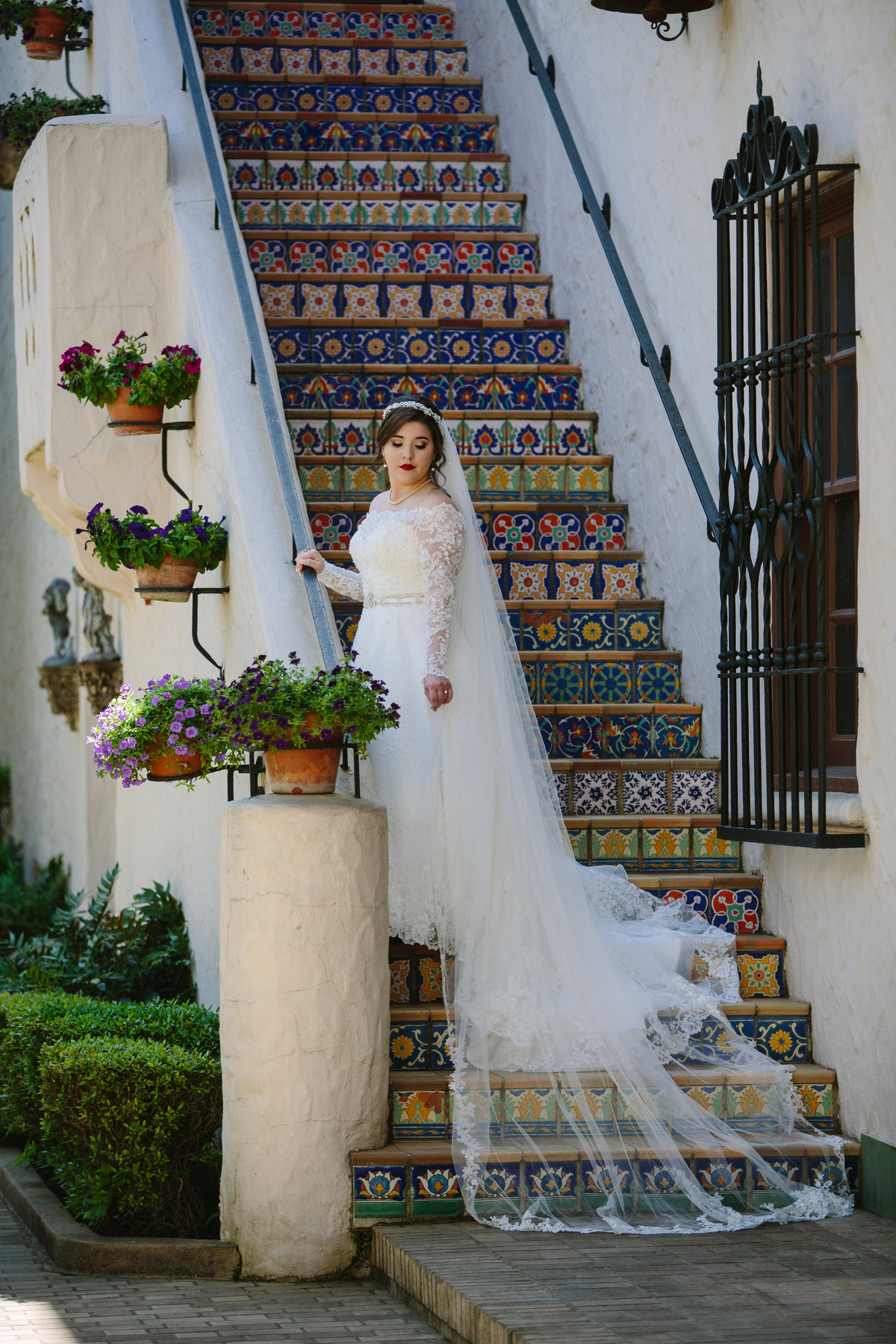 Bride standing on the tiled stairs at the McNay Art Museum for her bridal photo session.