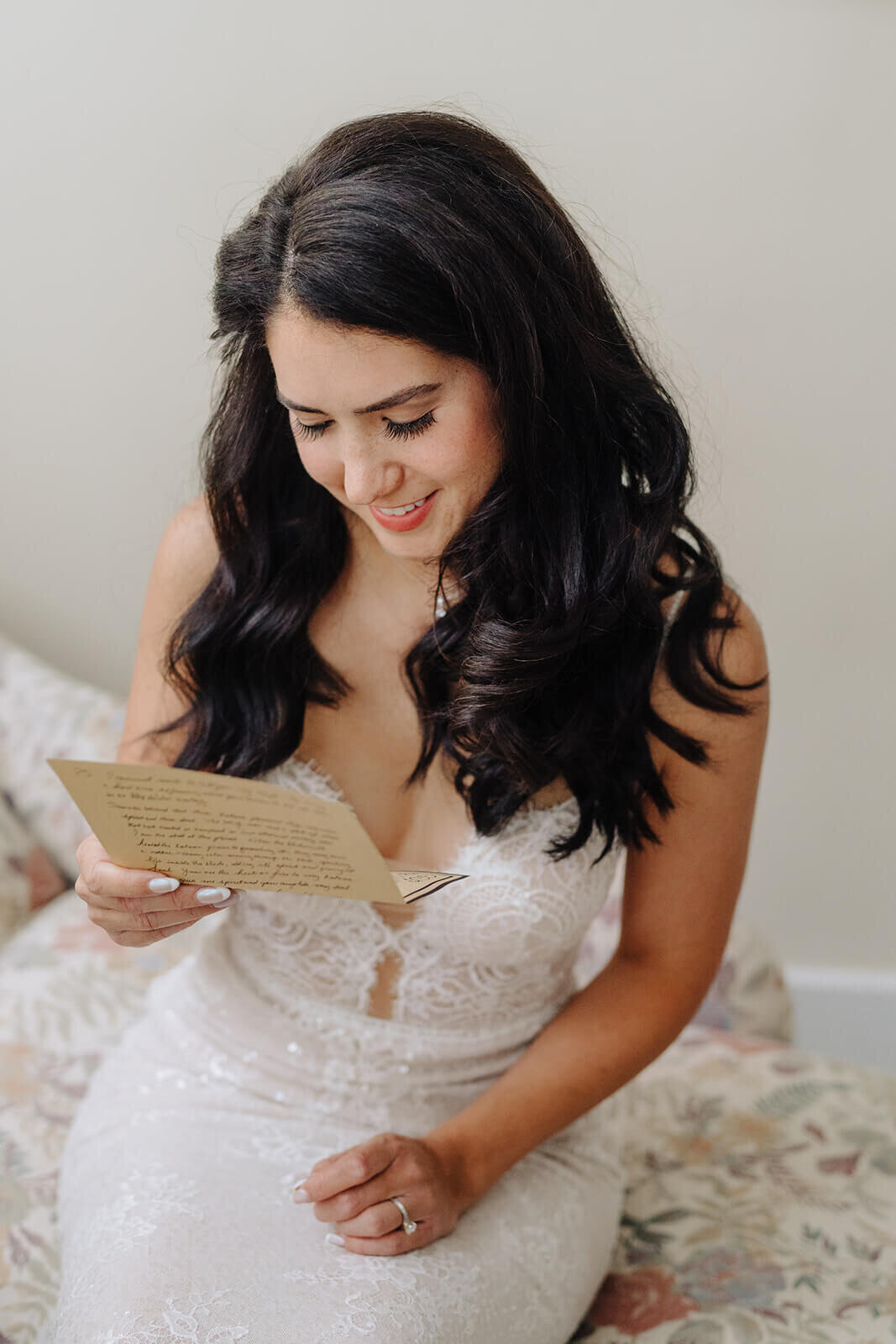 Bride smiling as she reads hand written note