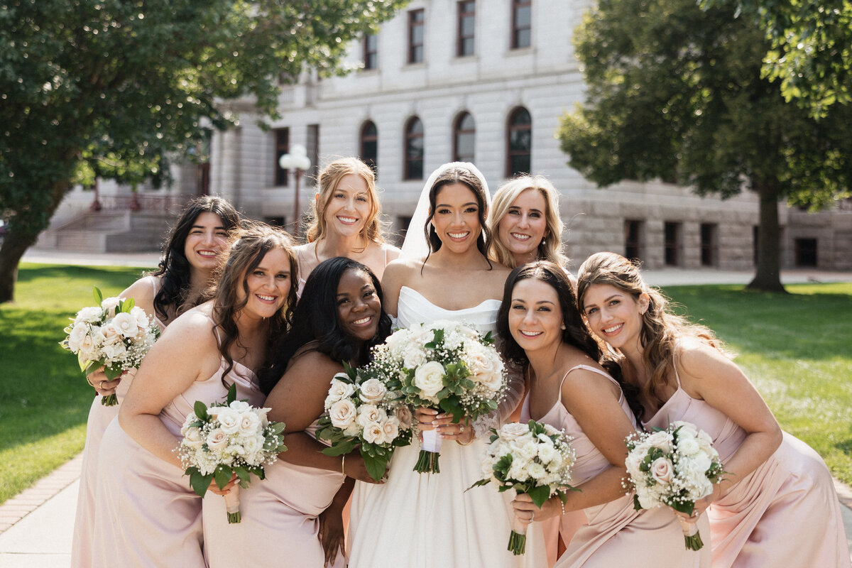 Groom lovingly kisses the bride on the head, surrounded by a peaceful and intimate setting.