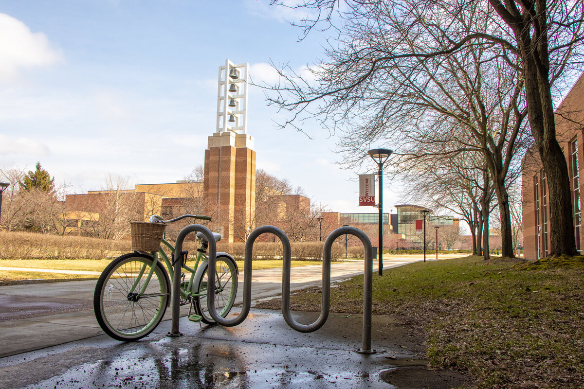 031721  bike in front of bell tower and zahnow library spring
