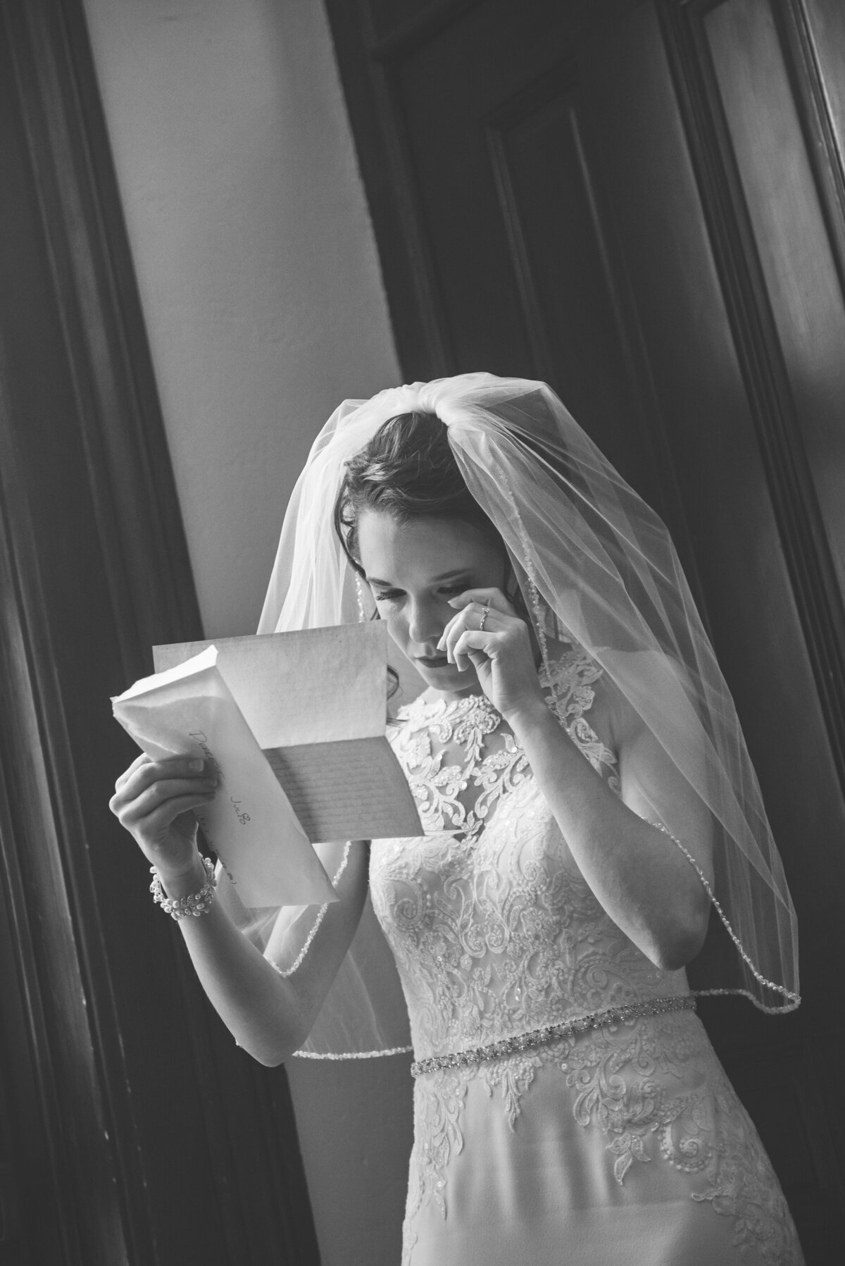 Bride crying reading a letter from groom.