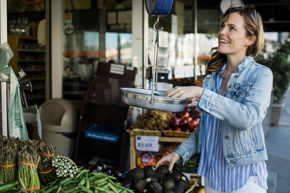 holistic nutrition coach shopping in outdoor market