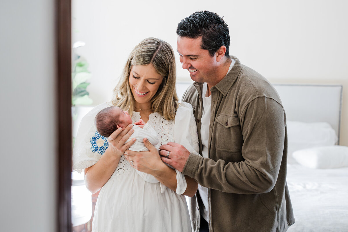 parents-in-their-hermosa-beach-home-looking-at-their-baby