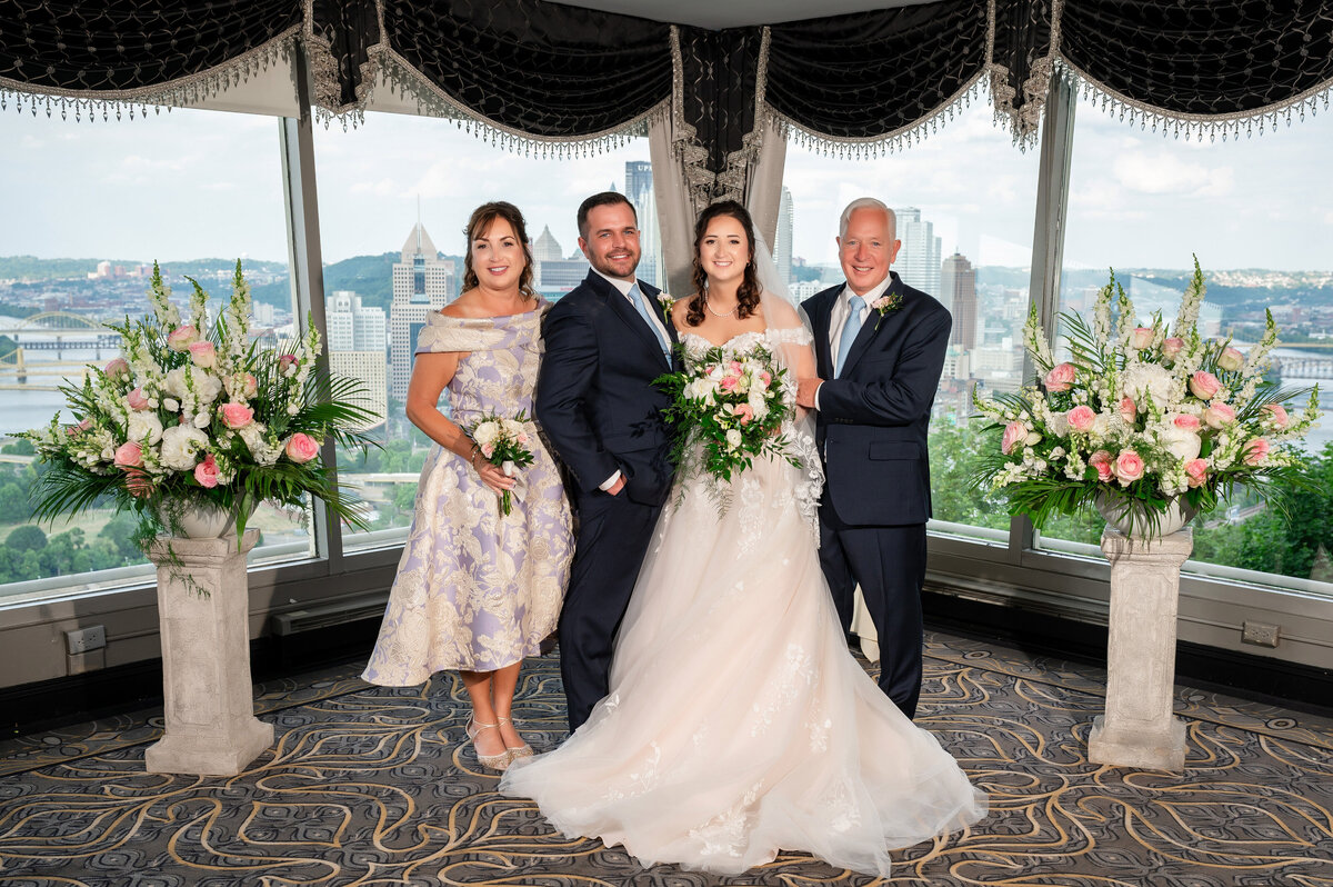 family photo on wedding day inside lemont restaurant with pittsburgh scenery