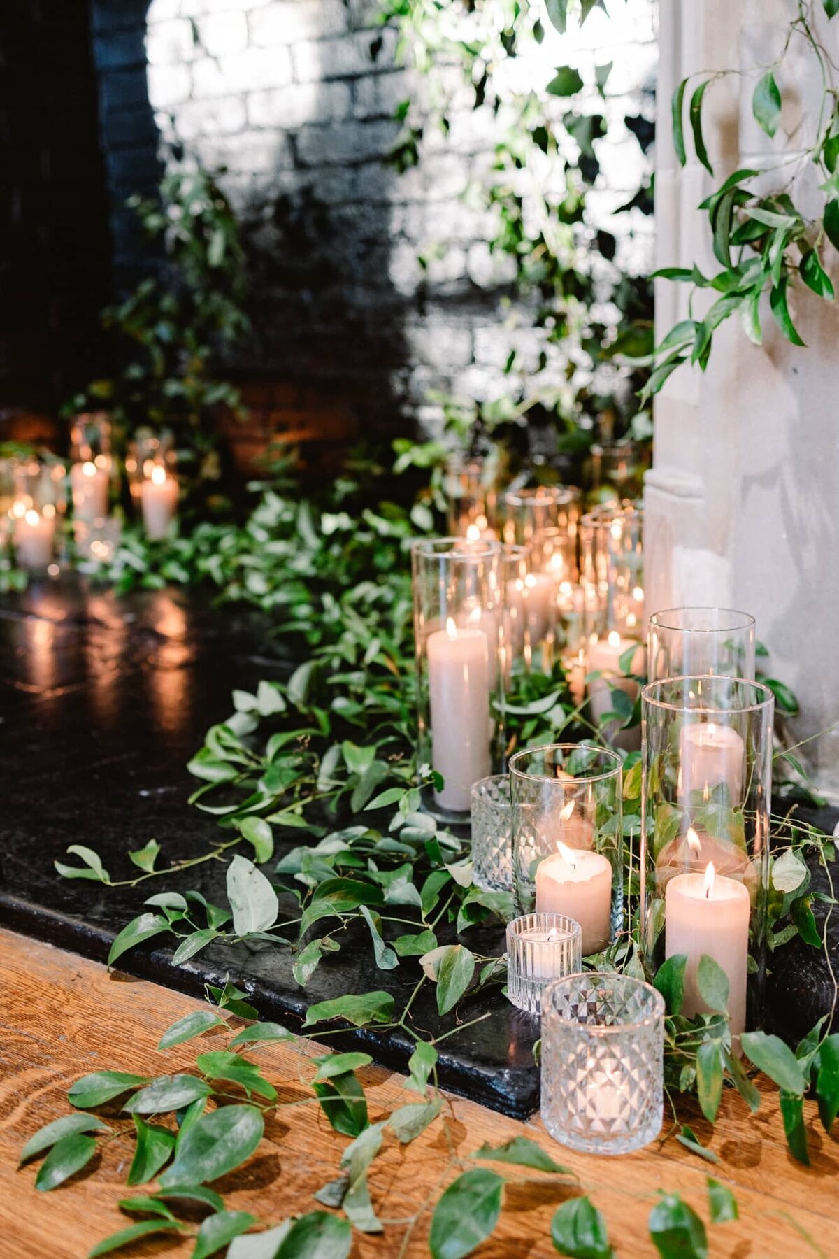 Candles and greenery in front of fireplace at Branch Museum Richmond wedding