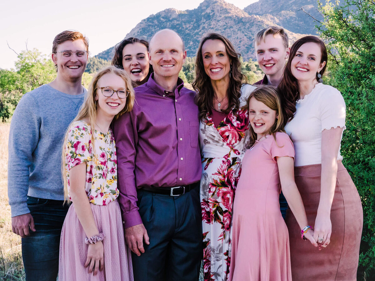 Family poses in front of Granite Mountain in a session with Prescott family photographer Melissa Byrne