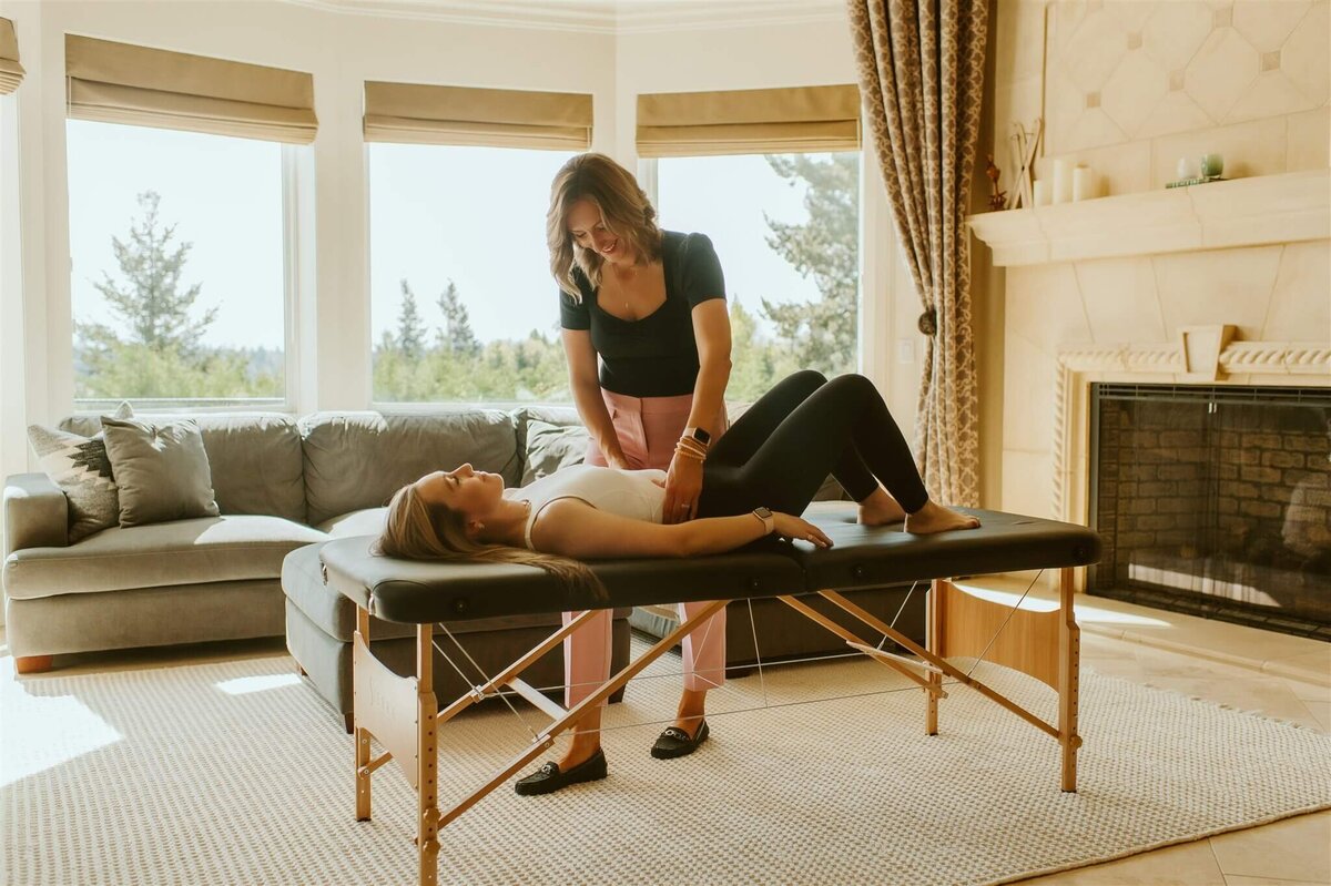 Dr Gwen works with a postpartum client during an in home concierge physical therapy session in Portland Oregon.