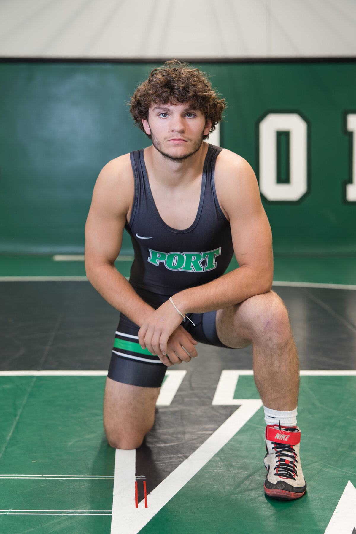 Senior guy in a wrestling singlet looking at the camera