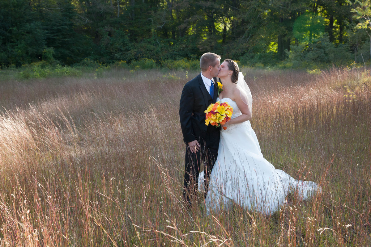 Bride and groom in field near The Riverhouse