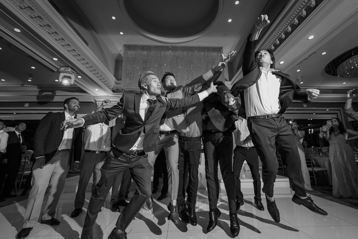 Single men try their luck and go after the bride's flower bouquet at reception party in Orange County California, photo by Tanya Parada