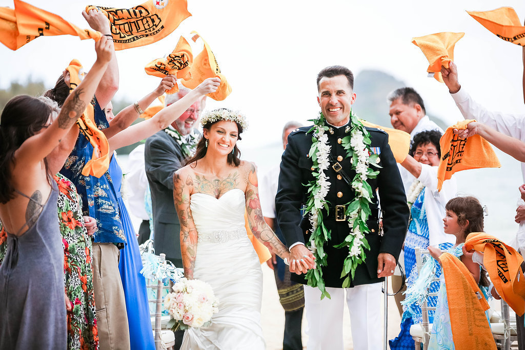 Guests wave terrible towels as couple walks down the aisle