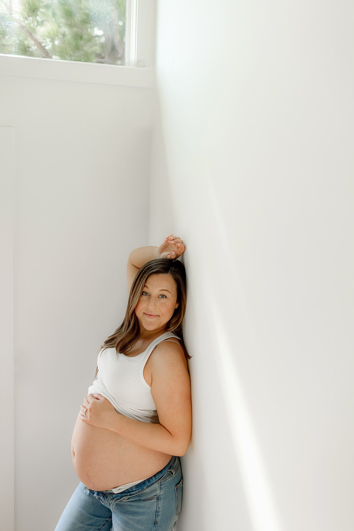 The Boulder lifestyle maternity photographer documents emotional moments during this pregnancy photo shoot at home.