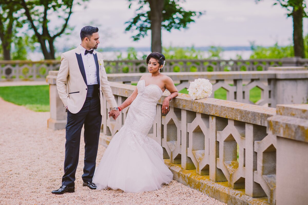 Indian bride in a white dress with groom on the wedding day at the Hempstead house at sands point preserve