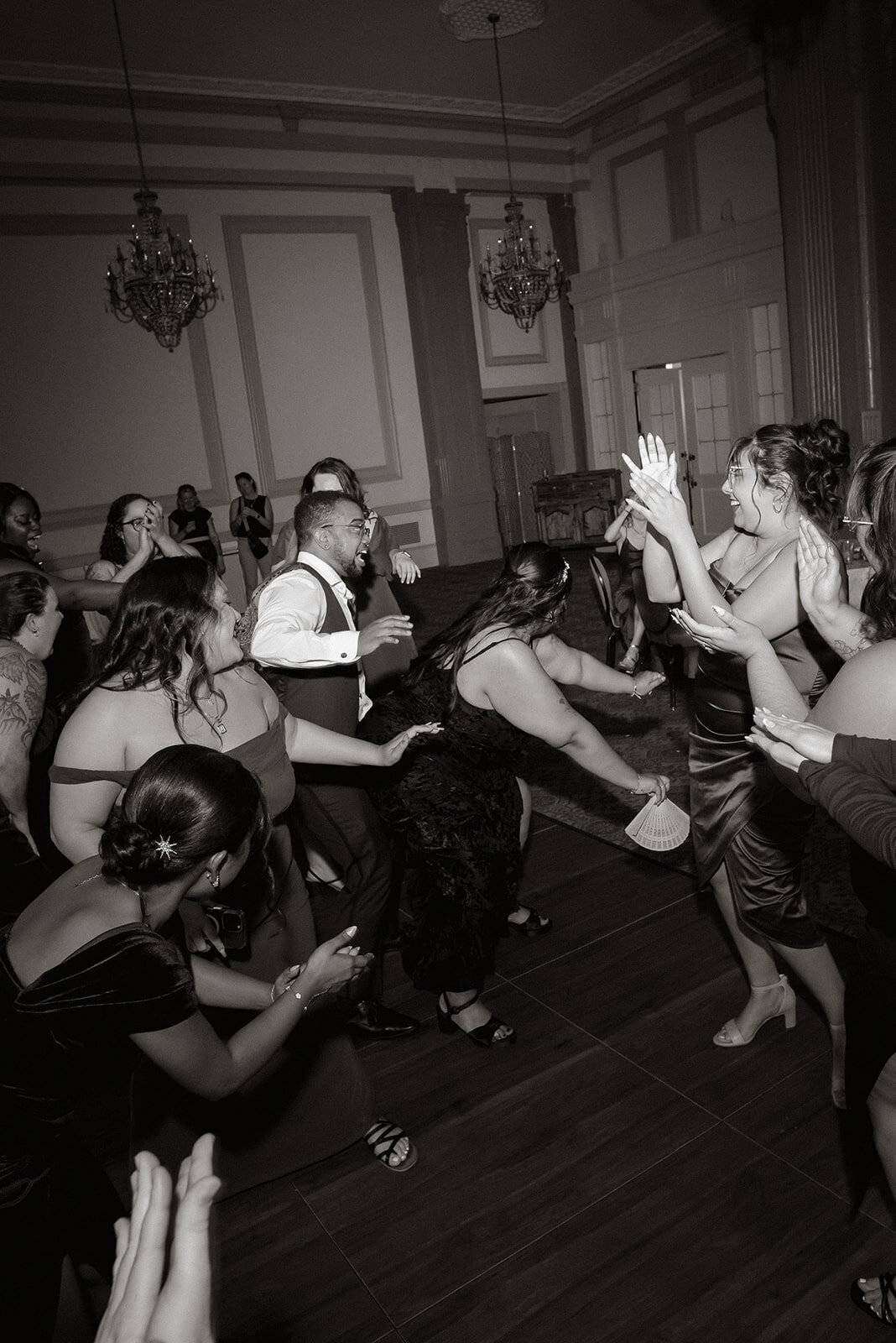 newlyweds dancing guests surrounding them