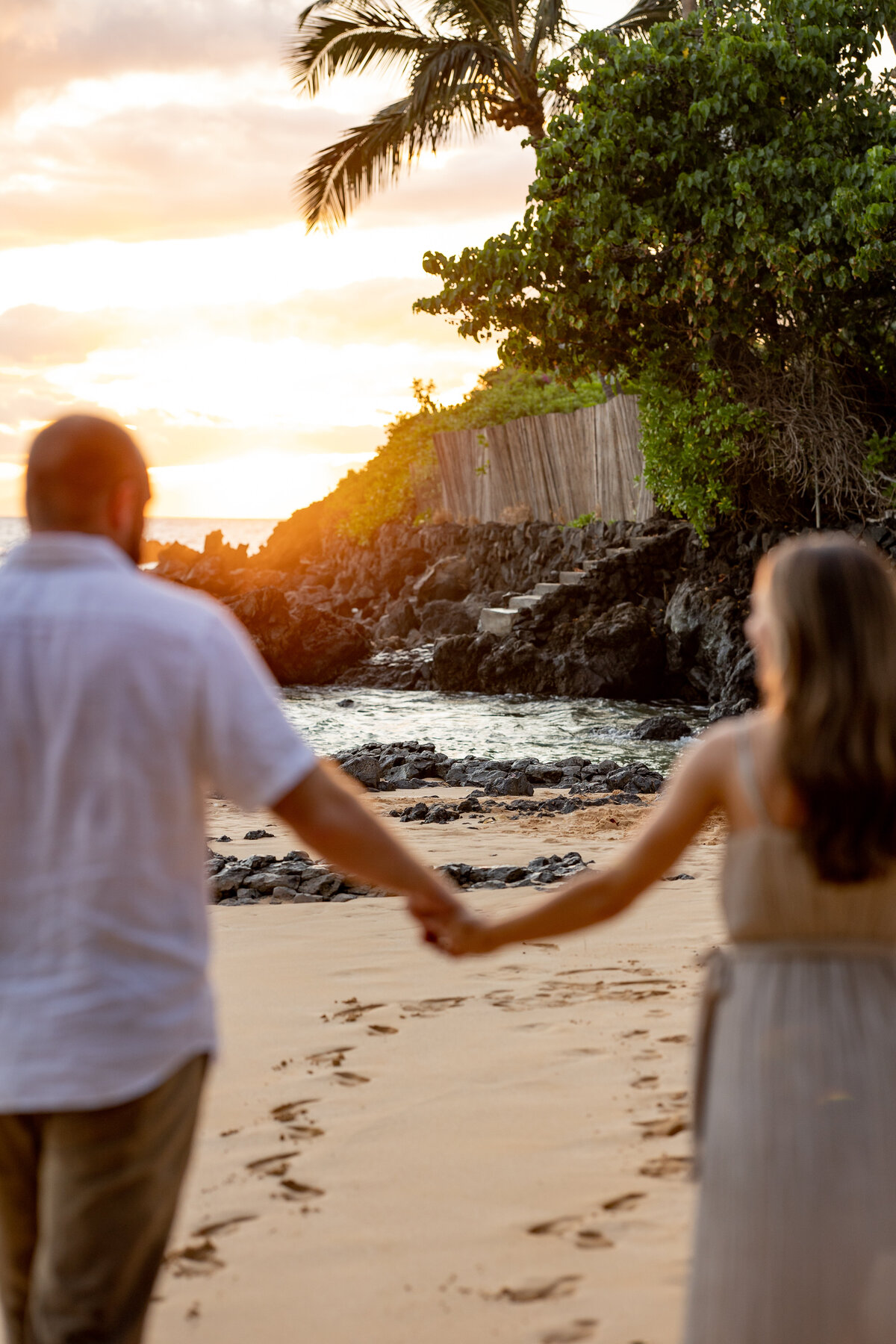 Hawaii Engagement Photographer captures couple walking on beach hand in hand