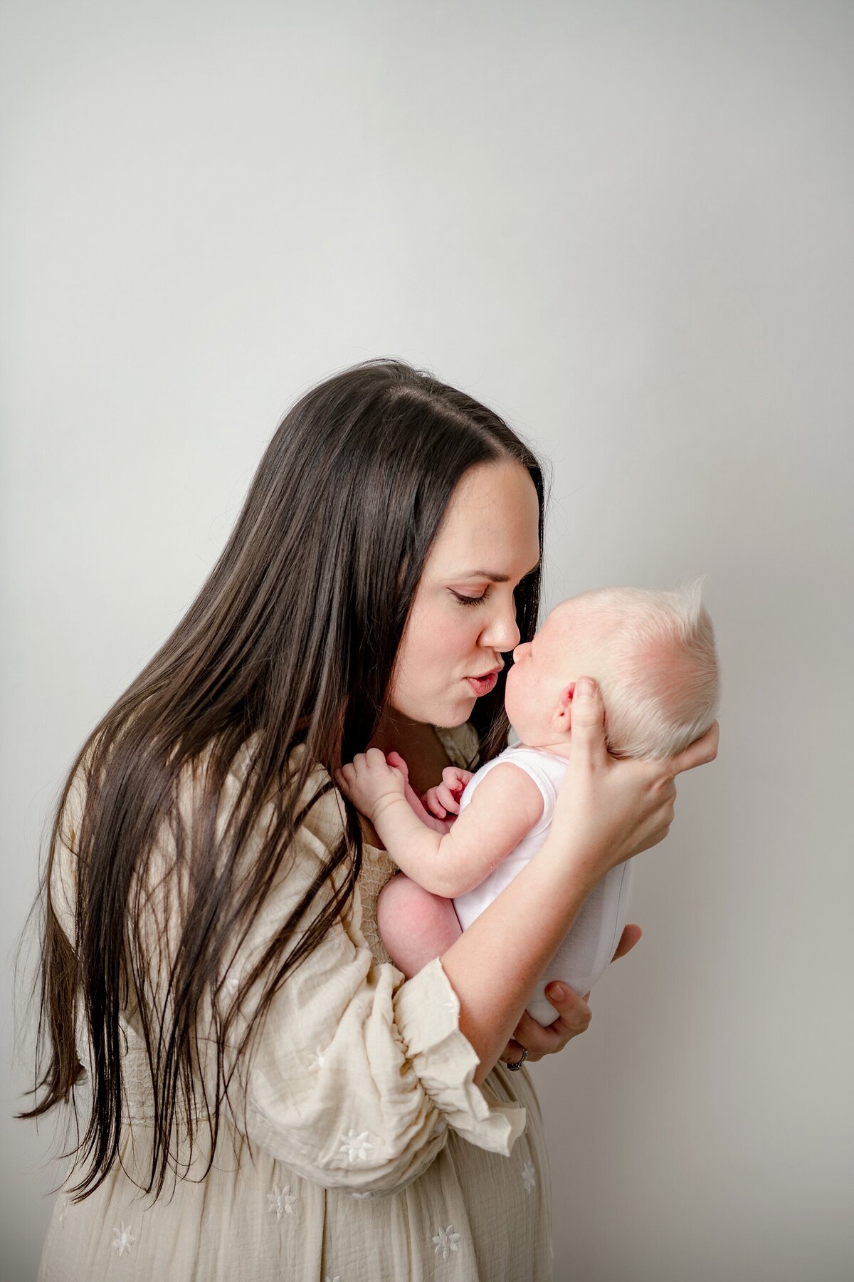 mom-holding-newborn-closely