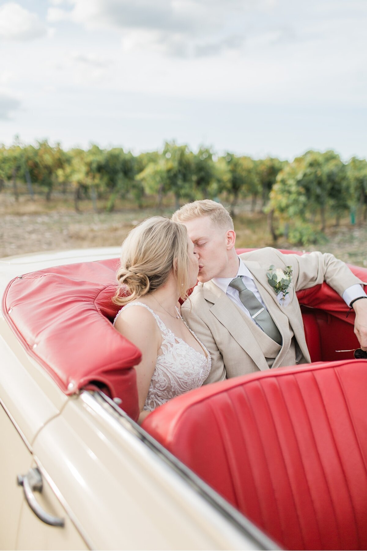 bride-groom-kissing-car