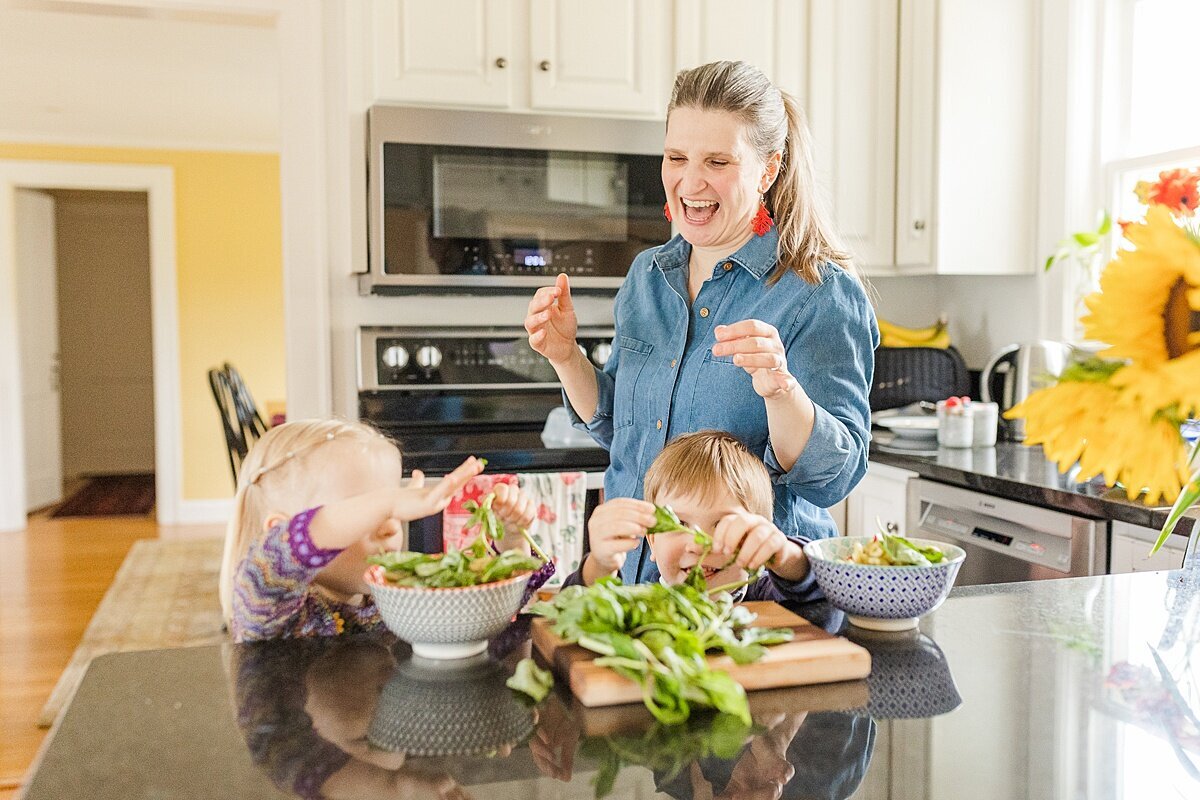 Doula cooks  with children during BURGEONING BUD POST PARTUM DOULA Branding photo session with Sara Sniderman Photography in Natick Massachusetts