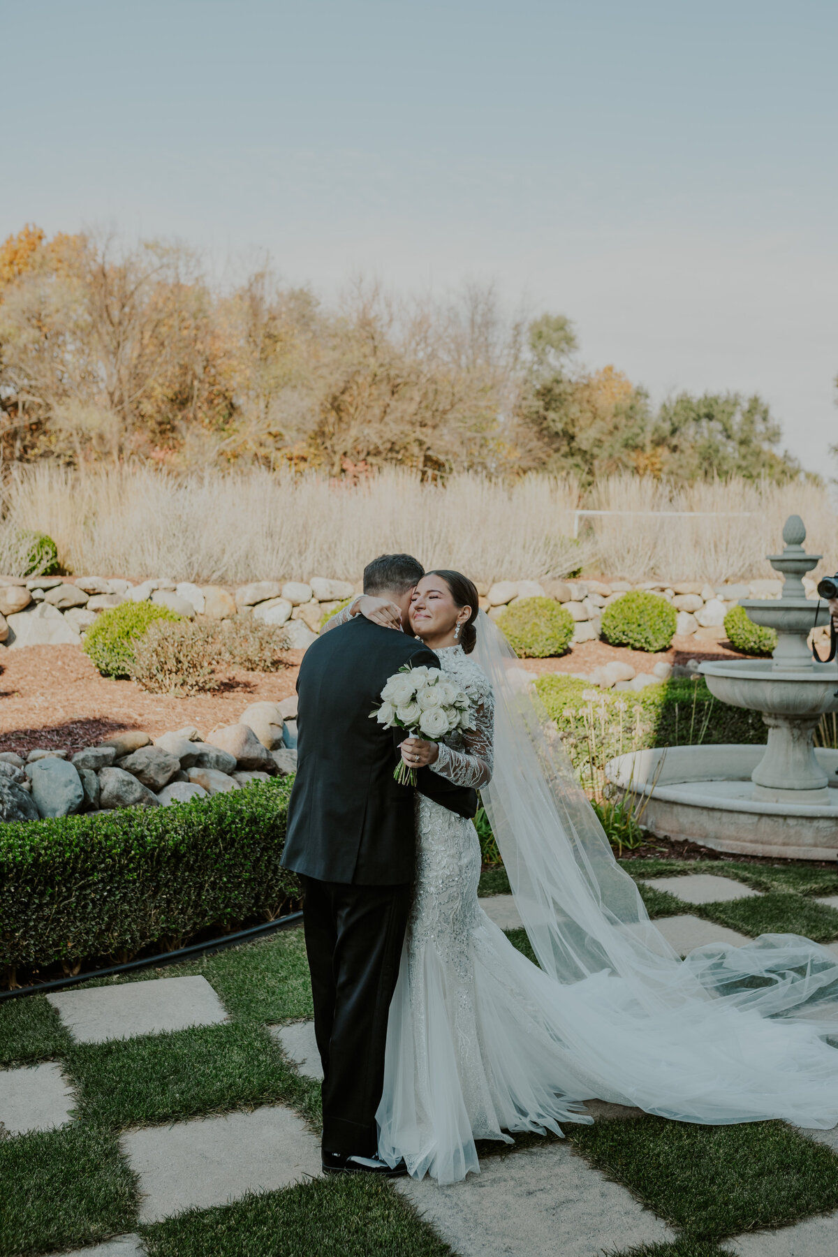 Bride and groom share a moment in a blooming garden, Indiana wedding venue.