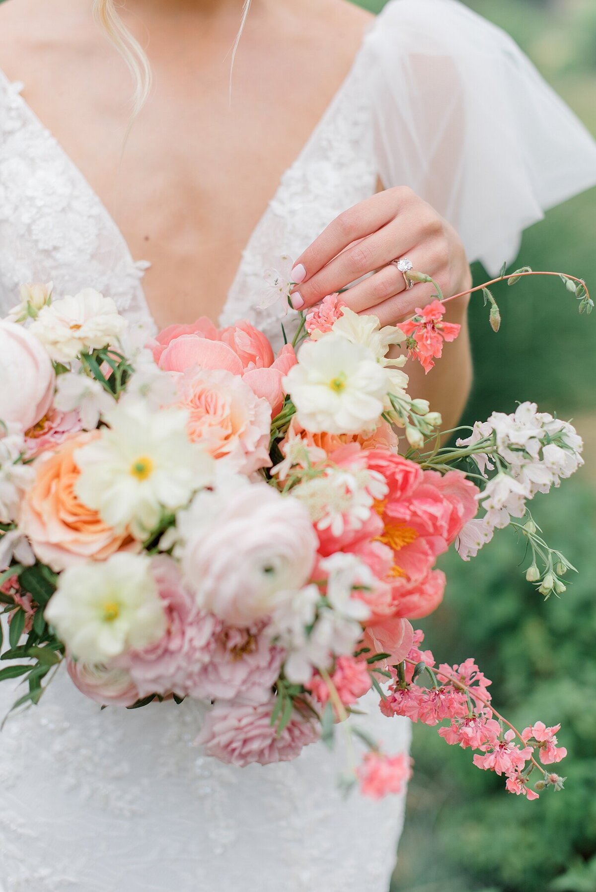 detail photo of bridal bouquet featuring cream, white and pink florals