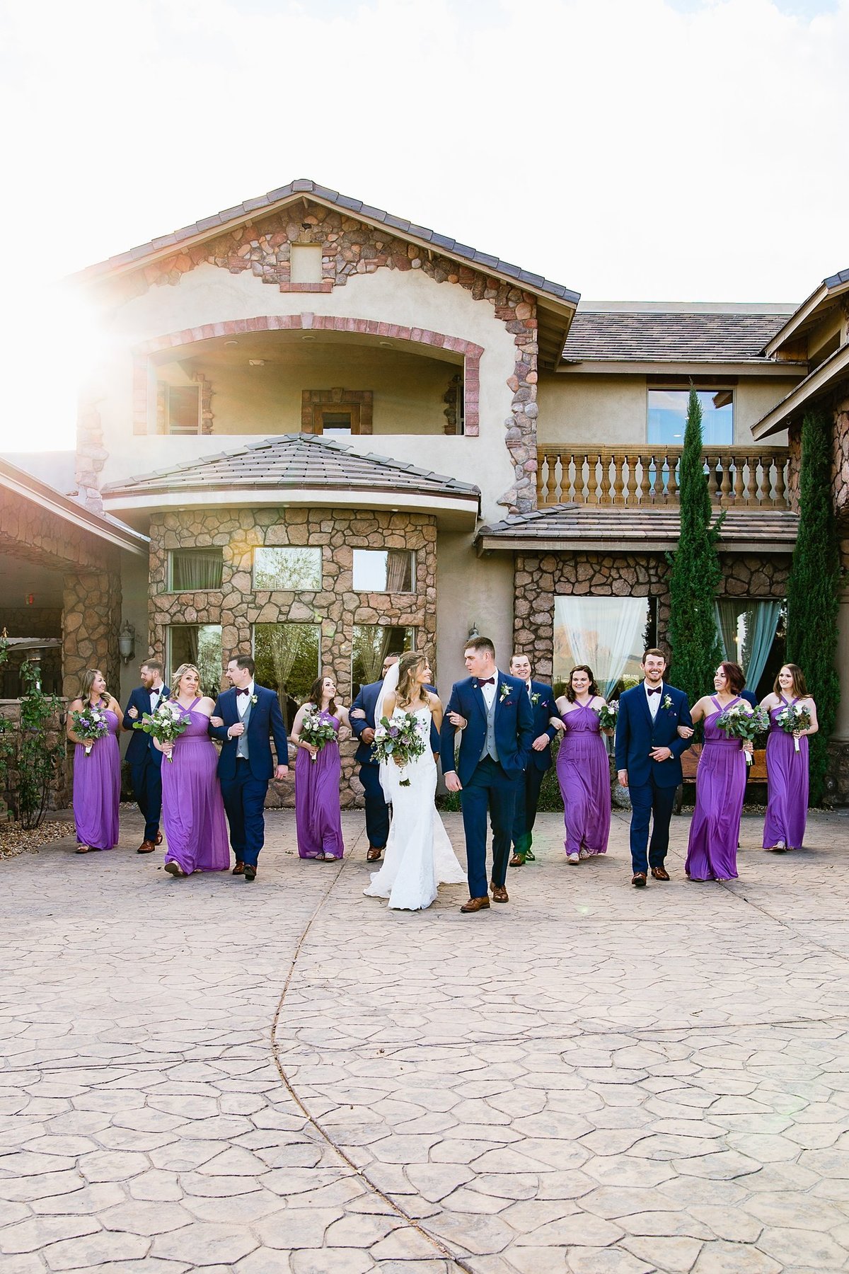 Bridal party walking together with the bride and groom at Superstition Manor by PMA Photography.