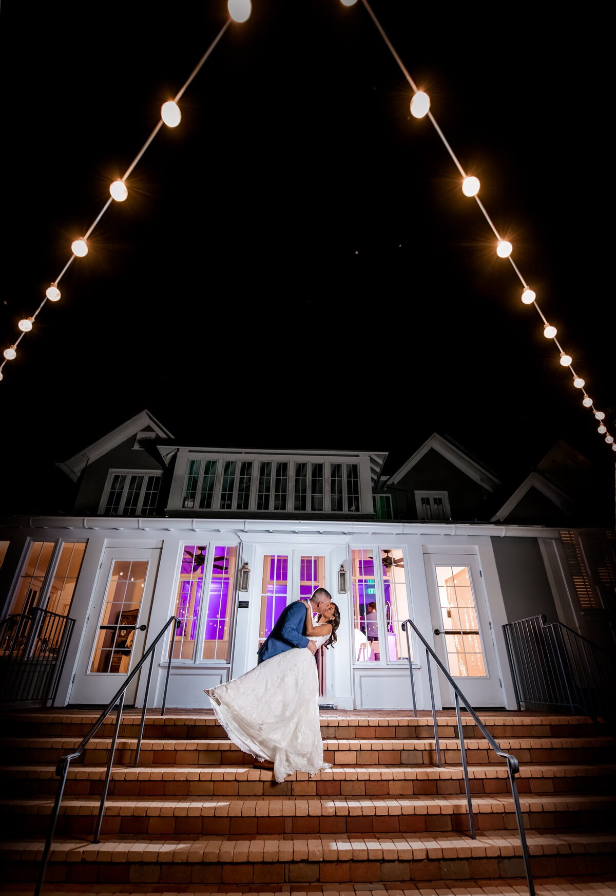 Nighttime wedding photo kissing and dip