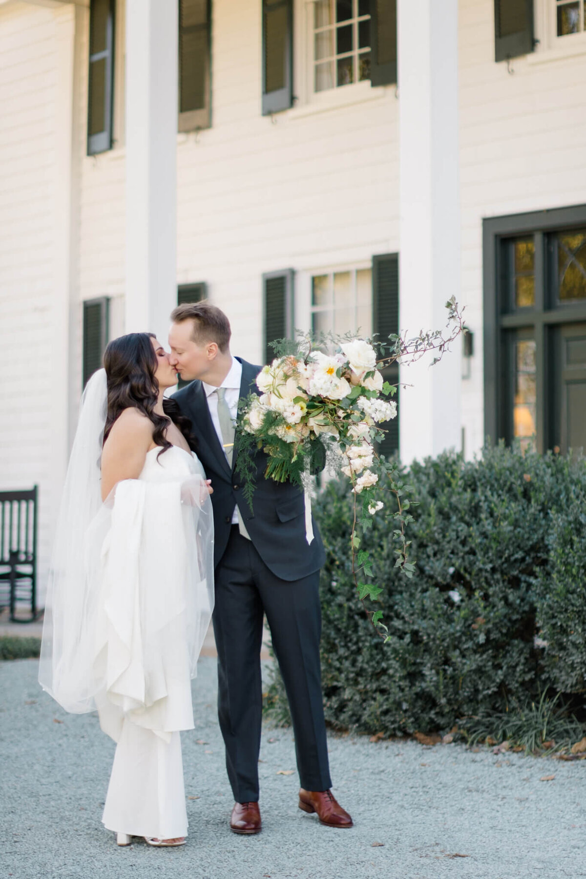 Bride and Groom kissing in front of The Clifton.