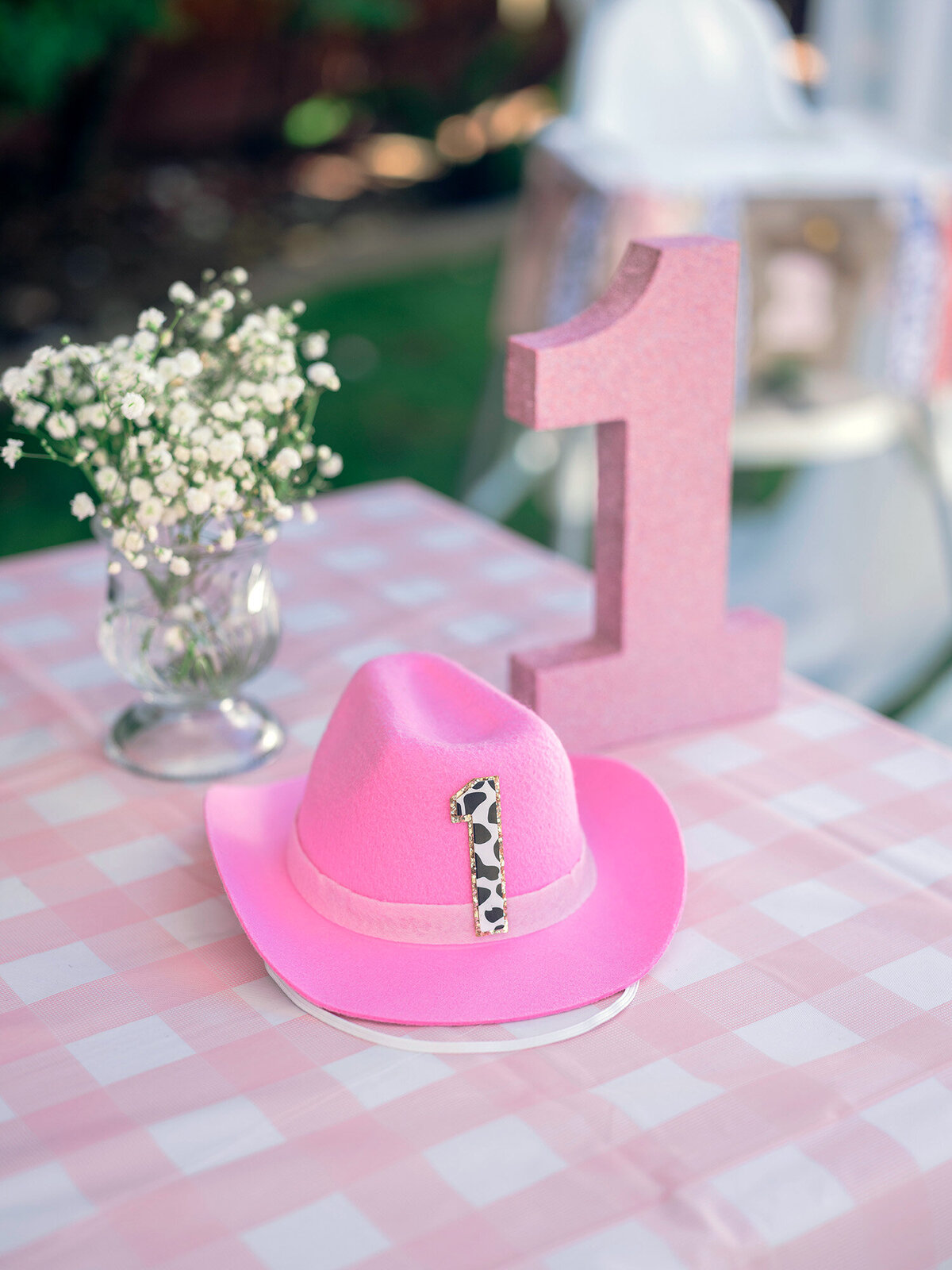 Close-up detail of cowgirl birthday hat with number one at a first birthday party in the San Francisco Bay Area.