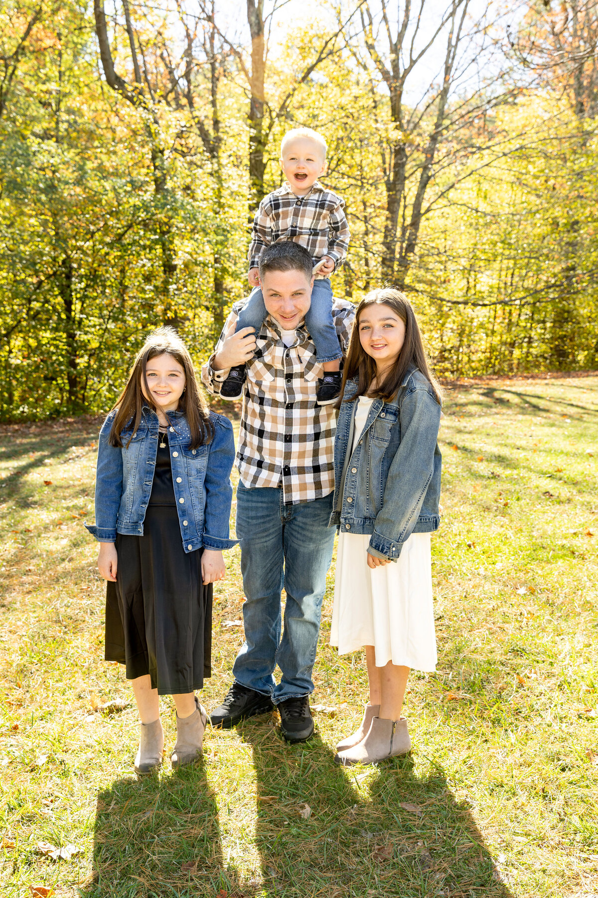 Smiling family portrait outdoors in Albany NY during fall foliage