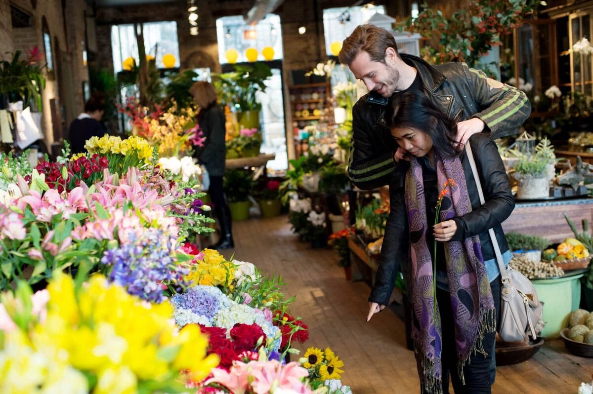 a couple go shopping for flowers during their all day engagement session