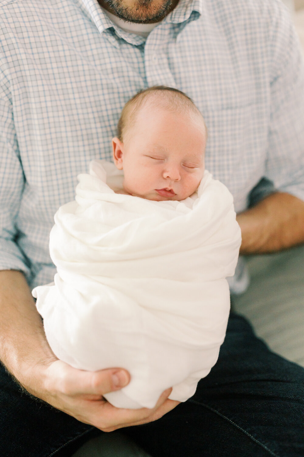 new-dad-showing-off-newborn-son