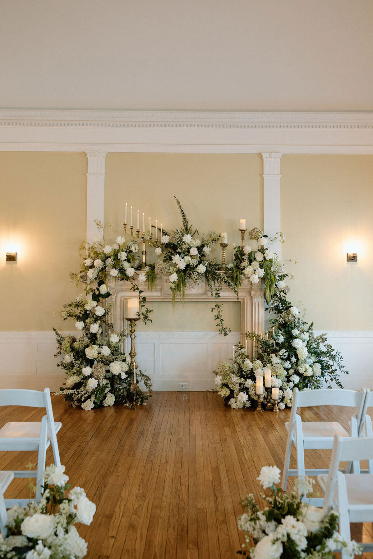 Floral wedding altar setup with white flowers and candles