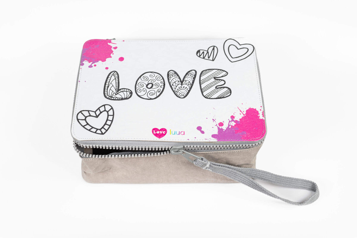 Close up product shot of a Luua lunchbox with the word "LOVE" writtin in big letters on it.