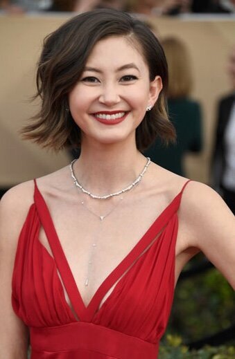 Kimiko Glenn wearing long red dress and red lipstick