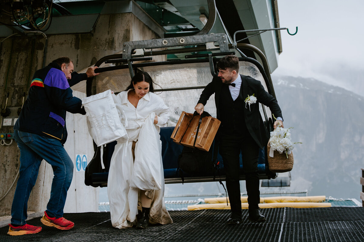 Cinque Torri elopement couple arriving by ski lift in the Dolomites.