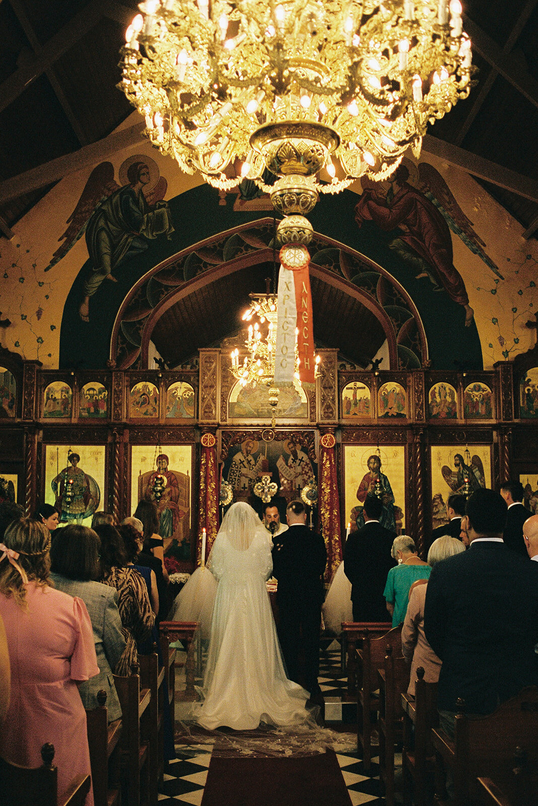 The couple’s ceremony in a Greek wedding church, captured with a timeless, documentary approach on 35mm film.