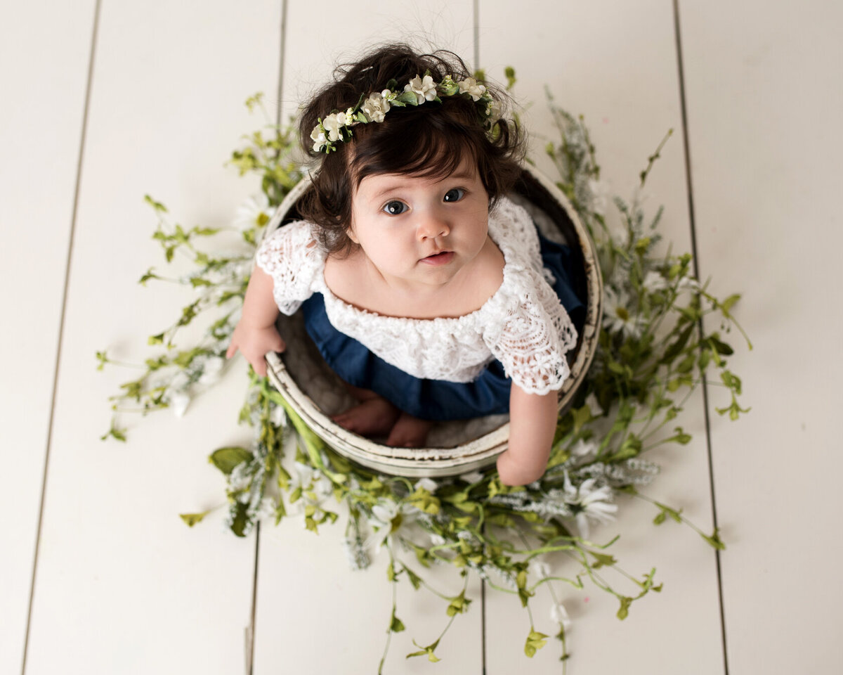 Lovely baby in a flowery bucket and flower headdress photoshoot in Houston