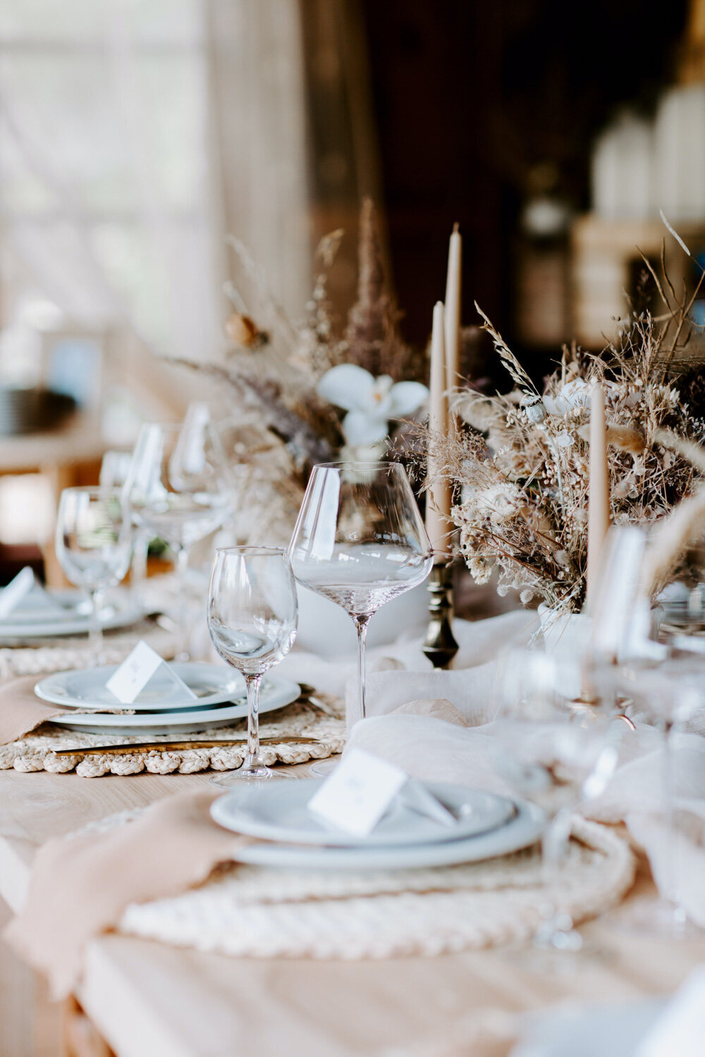 Dining table with flowers, candles and wine glasses