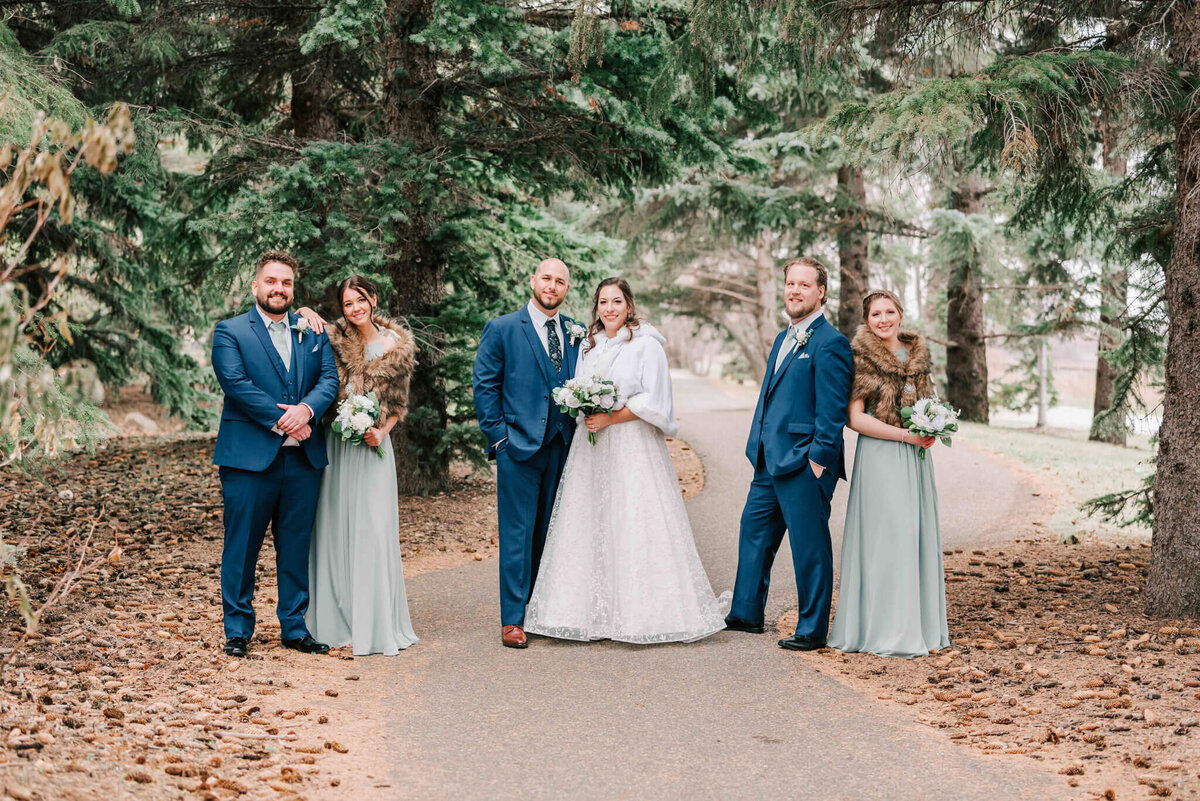 Wedding party stands separated in "couples". 